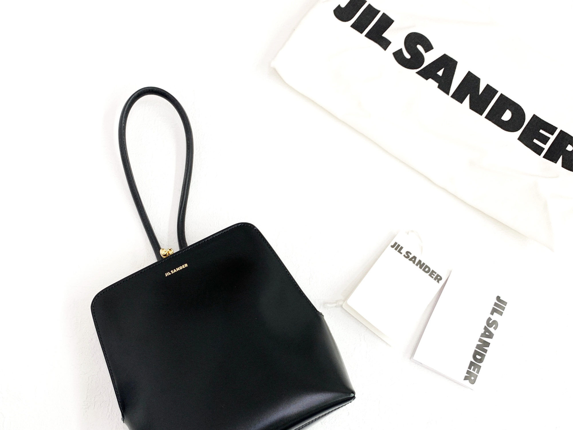 JILSANDERのバッグと布袋の画像